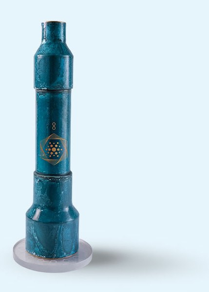 Aqua Energizer On-the-Go structured water device with blue mineral patina, standing on its crystal clearing stand