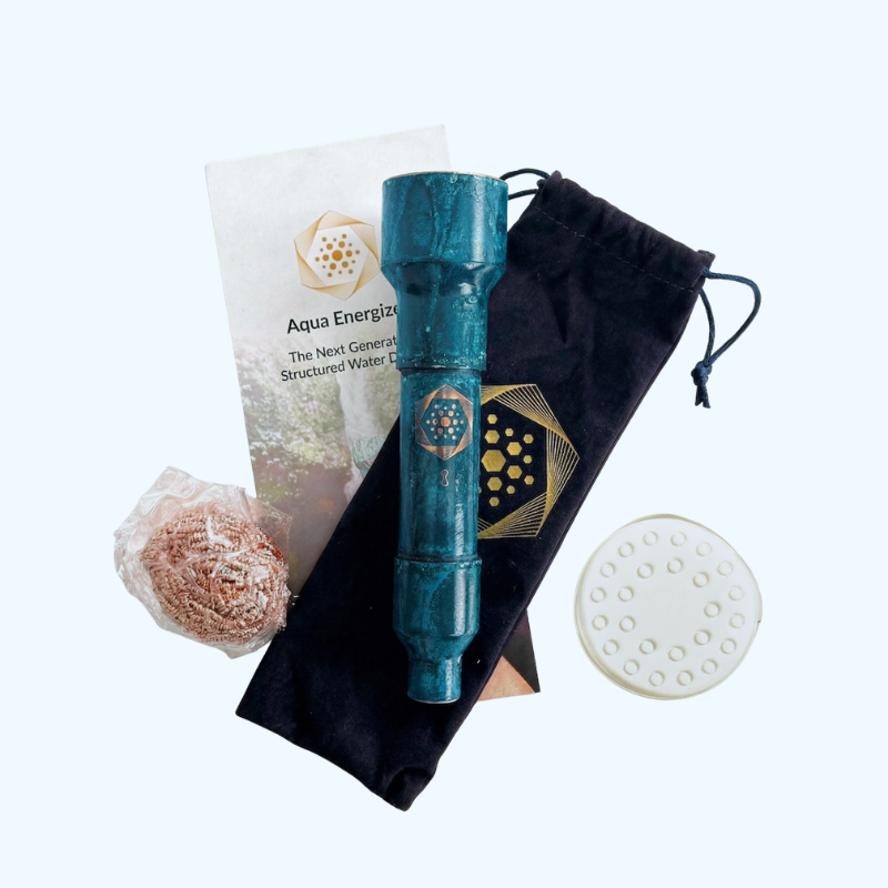 Certainly! Here’s a revised version using your product data: The Wellness Enterprise’s Aqua Energizer On-the-Go Sternagel Special Offer (Including Care Kit) features a blue cylindrical structured water device, drawstring pouch, copper scrubber, brochure, and white disc with holes—each thoughtfully arranged on a light background—offering the promise of natural energy and enhanced hydration.