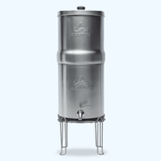 Stainless steel gravity water filter with a spout and stand, featuring the Alexapure logo on both the upper and lower chambers.