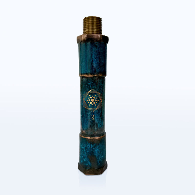 The Aqua Energizer Shower Structured Water Device by Aqua Energizer features a cylindrical blue and brass cartridge with a threaded top and a gold geometric design, shown standing upright on a white background.