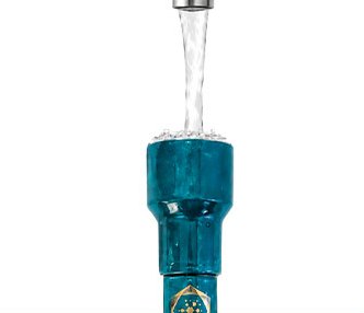 Water pouring from a tap into the copper funnel of the Aqua Energizer On-the-Go