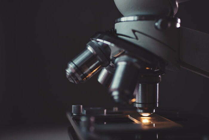 Microscope analyzing a water sample in a low light